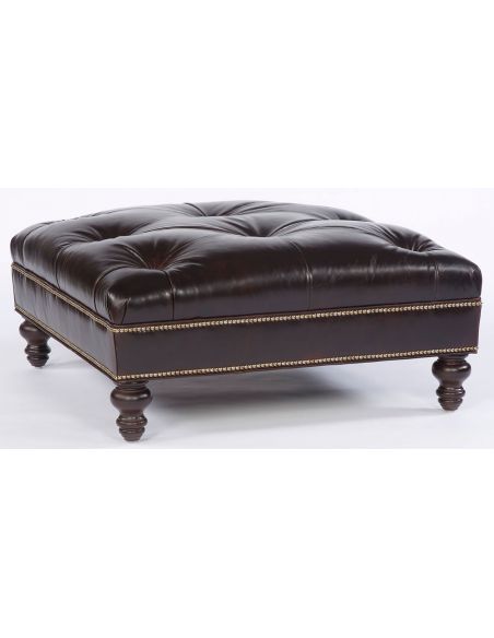 Tufted square leather ottoman. 94