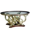 Dining Tables Glass topped dining table with intricate hand carved base.