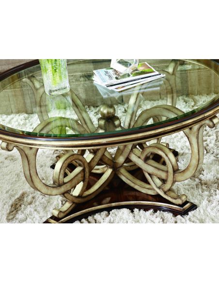 Dining Tables Glass topped dining table with intricate hand carved base.