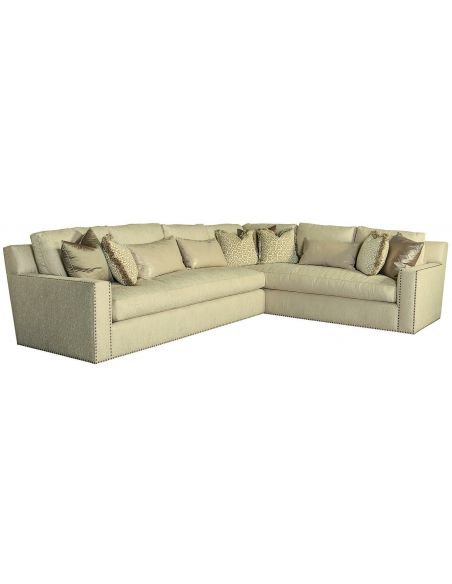 Sectional covered in ivory fabric with nailhead trim
