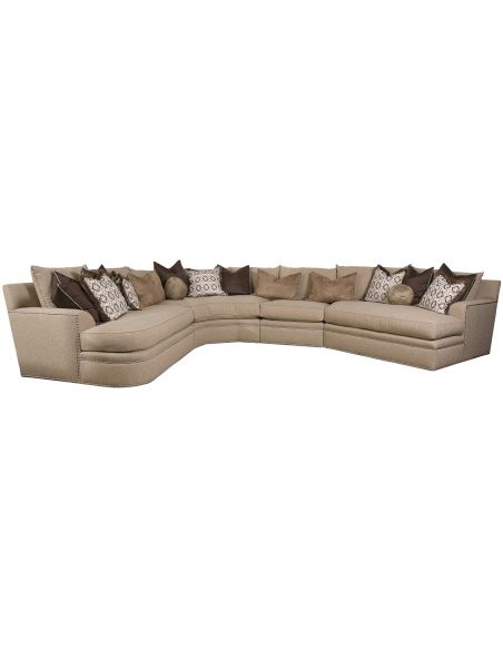 Beige sectional with nailhead trim, and coordination accent pillows
