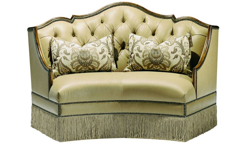 SETTEES, CHAISE, BENCHES Leather settee with wood trim and chic fringed skirt