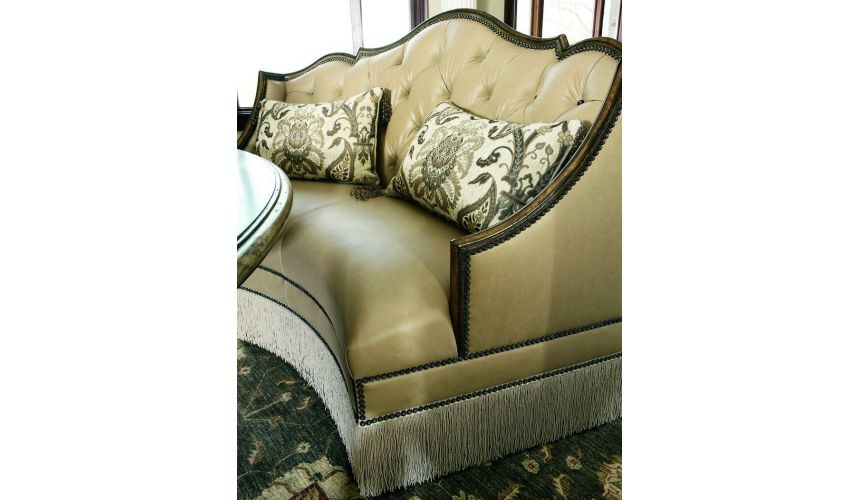 SETTEES, CHAISE, BENCHES Leather settee with wood trim and chic fringed skirt