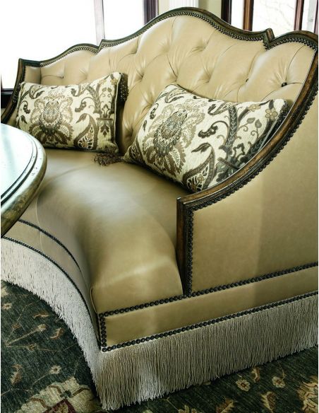 SETTEES, CHAISE, BENCHES Leather settee with wood trim and chic fringed skirt