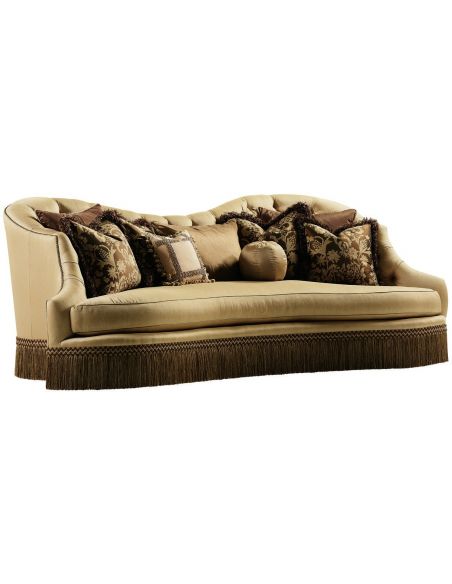 Bisque colored sofa with beautiful curved lines and fringed skirt