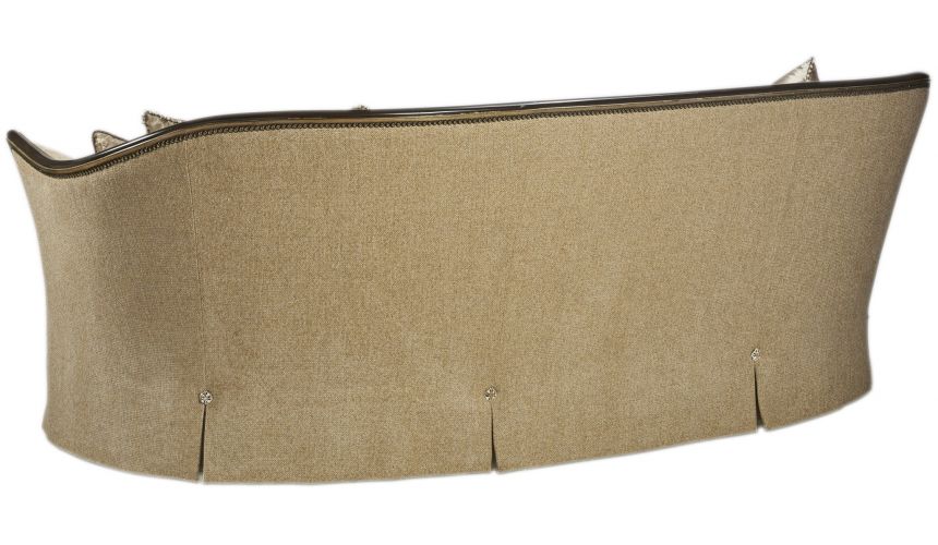Curved sofa covered in a luxurious tufted oatmeal fabric