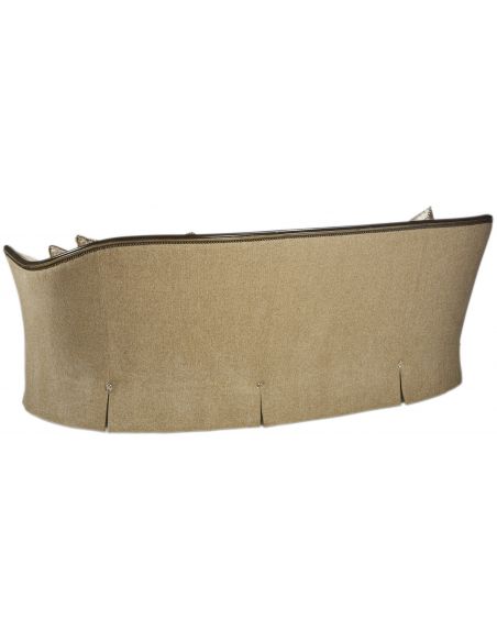 Curved sofa covered in a luxurious tufted oatmeal fabric