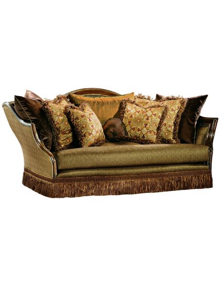 Sofa covered in warm earth toned fabrics with hand carved wooden accents
