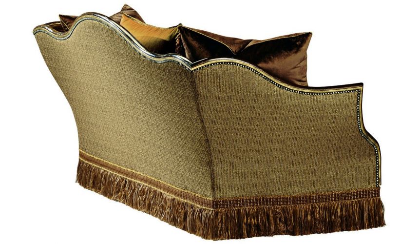 SOFA, COUCH & LOVESEAT Sofa covered in warm earth toned fabrics with hand carved wooden accents