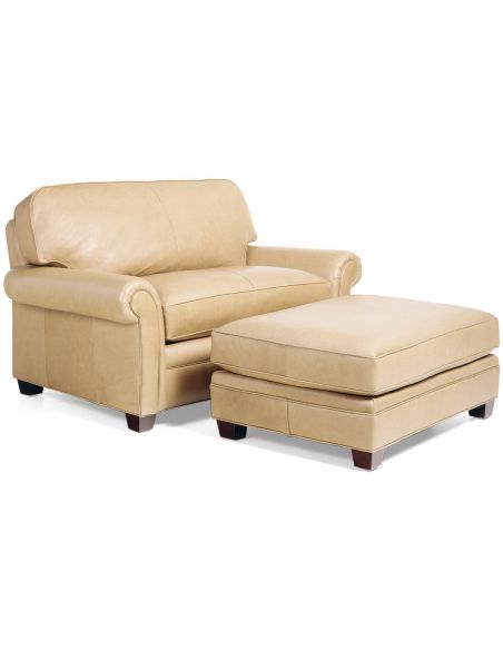 Cream colored armchair with matching ottoman
