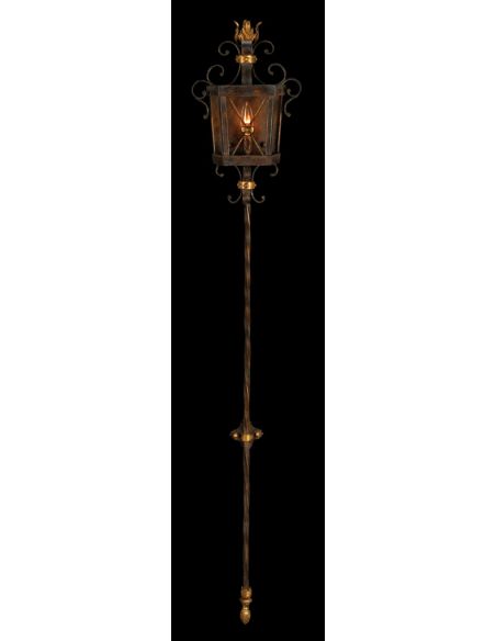 Sconce in antiqued finish with gold leaf accents. Features open cage