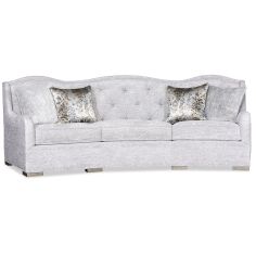 elegant and intricately carved tufted sofa offers a sophisticated touch