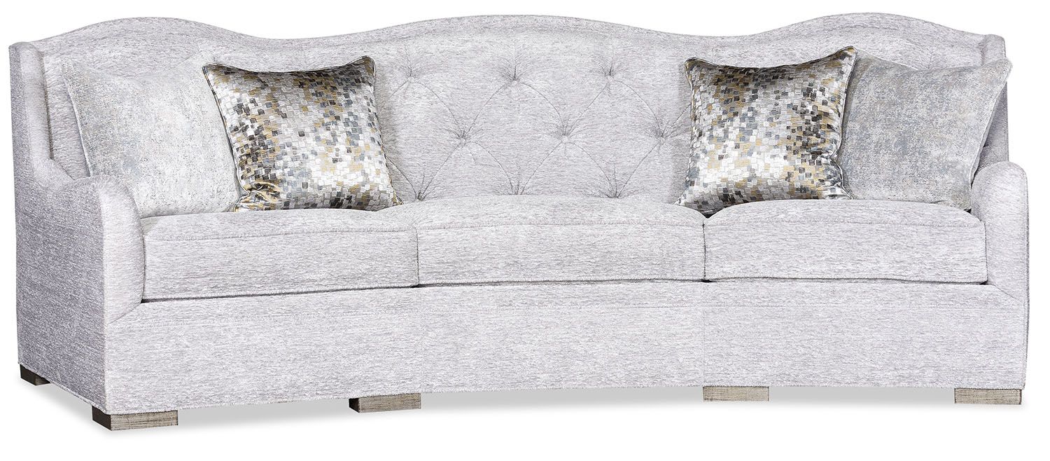 elegant and intricately carved tufted sofa offers a sophisticated touch