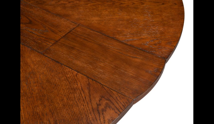 70-inch round table with self-storing leaves. Palladio finish on oak wood
