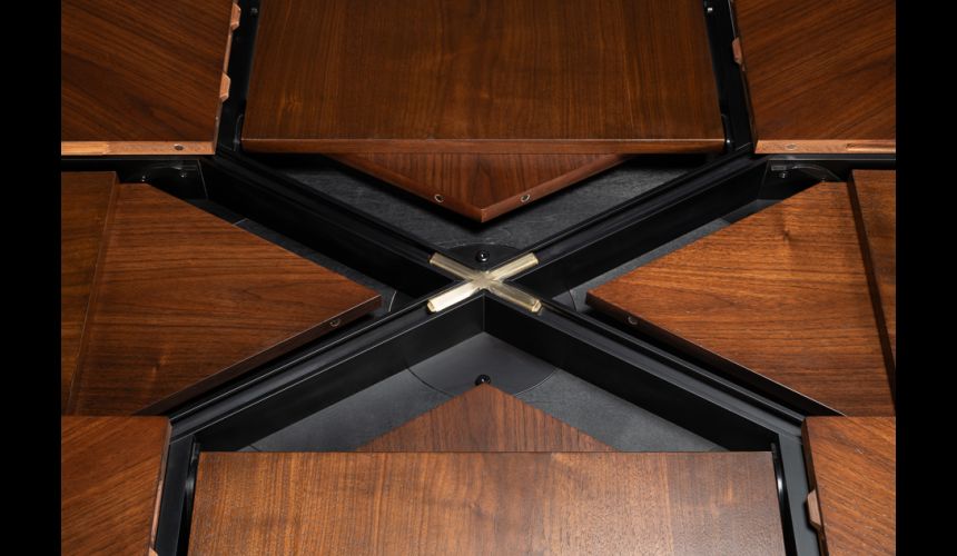 Rectangular expandable Jupe table with self-storing leaves.