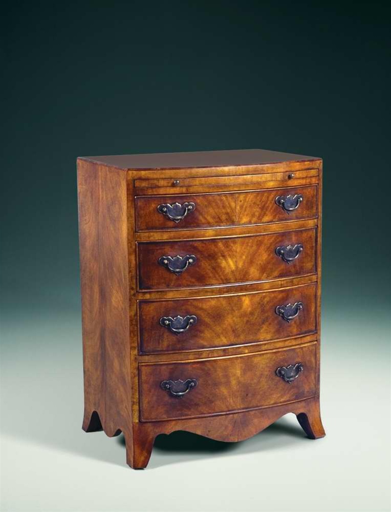 Chest of Drawers A Regency walnut & mahogany bowfront chest of drawers