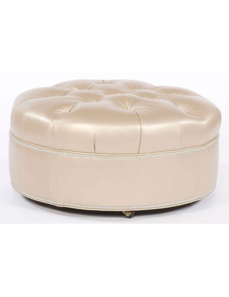 Tufted round ottoman. Grand home furnishings. 82