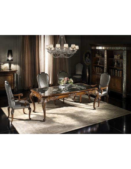 Fine carvings and a etched glass top highlight this dining set.