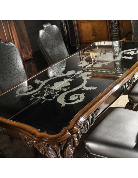 Dining Tables Fine carvings and a etched glass top highlight this dining set.