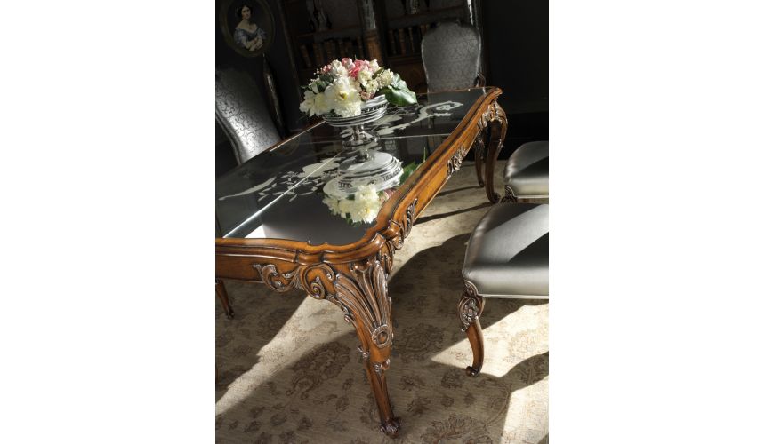 Dining Tables Fine carvings and a etched glass top highlight this dining set.