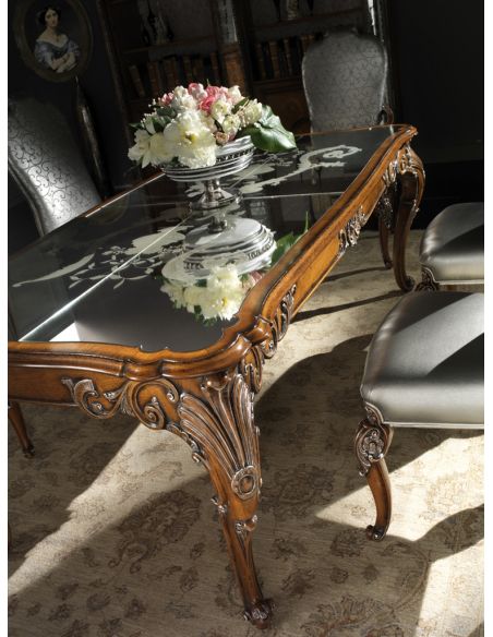 Dining Tables Fine carvings and a etched glass top highlight this dining set.