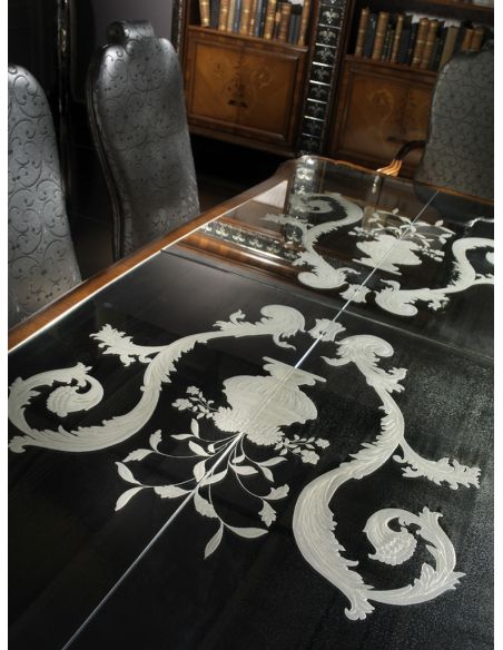 Dining Tables Fine carvings and a etched glass top highlight this dining set.
